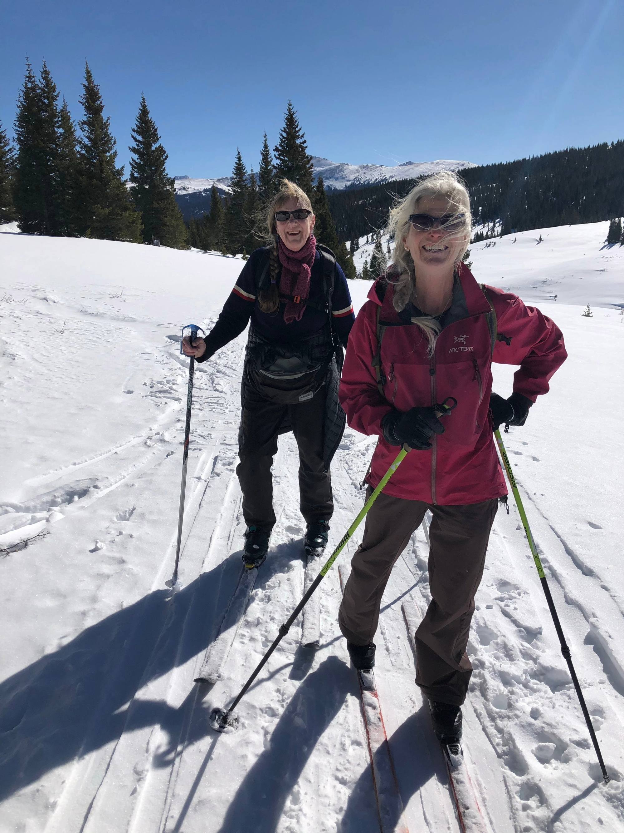 Two women in their 50's cross country skiing in Colorado on Vail Pass