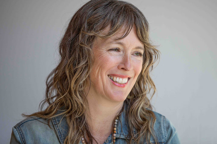 Attractive older woman with long light brown hair smiling